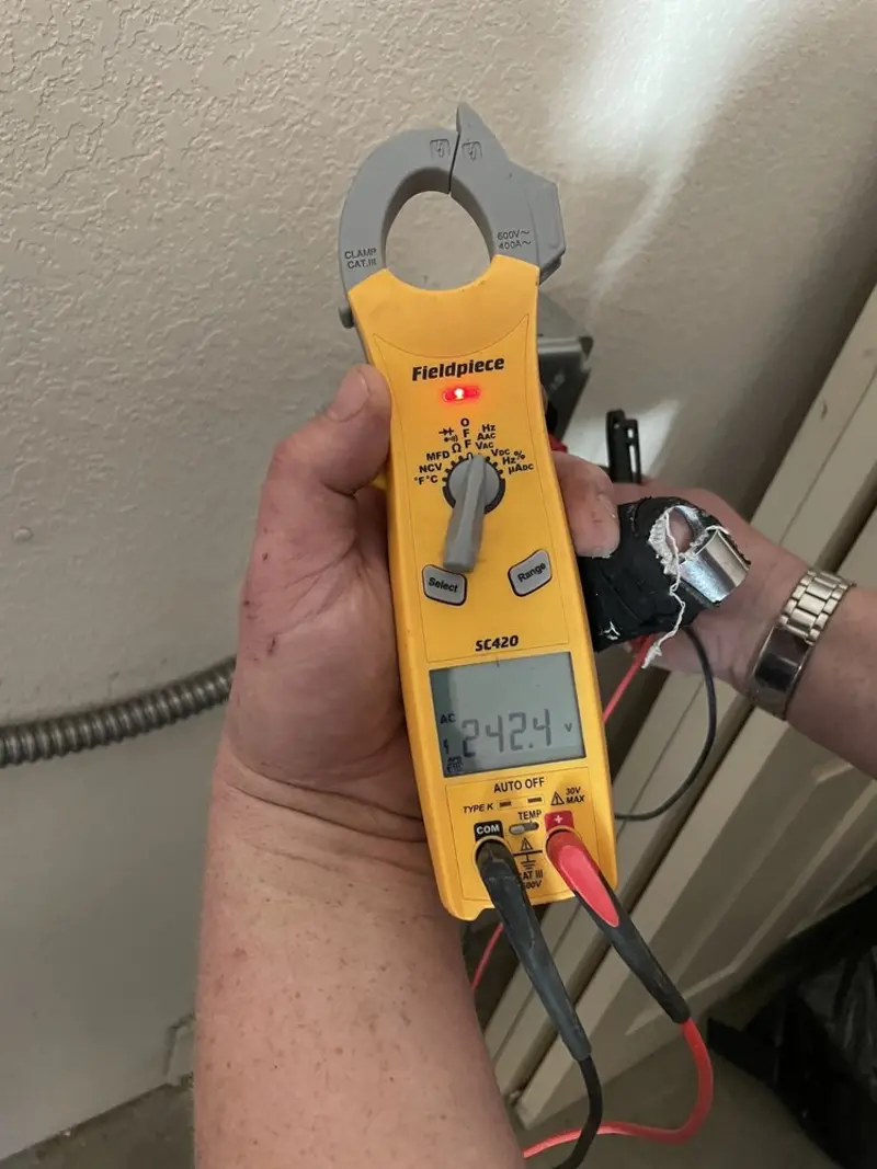 Voltage testing with clamp meter during Recessed Lighting Installation in Wayzata